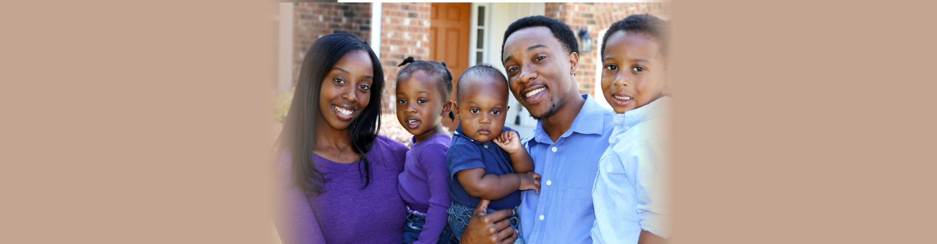 African American family together outside their home